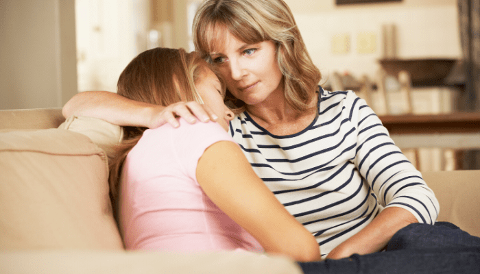 Mother Comforting teen daughter raising responsible adults