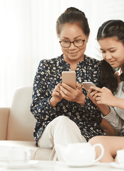 Mom and Daughter looking at cell phone best parenting apps for 2020