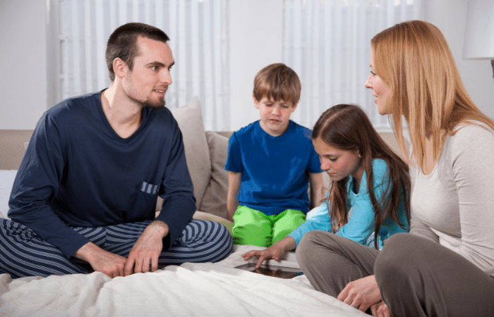 family activities for the weekend mom dad and boy and girl sitting on floor in a circle