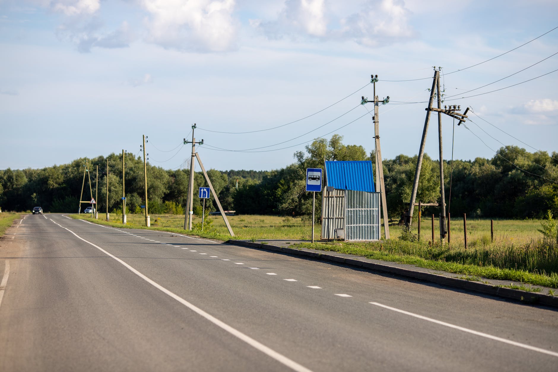 utilities for moving away photo of a road near signages and utility poles