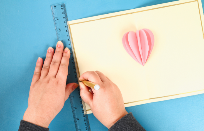 DIY Valentine's Day Cards for Kids drawing a border around the inside of a card.