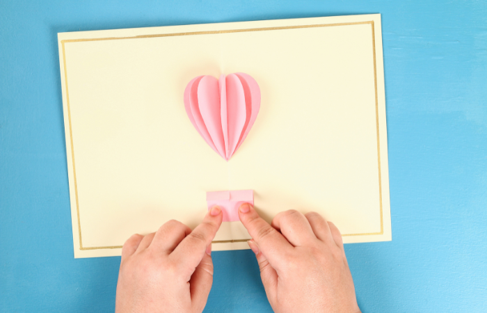 diy valentine's day cards for kids gluing a square to the fold of a card creating a basket for a hot air balloon