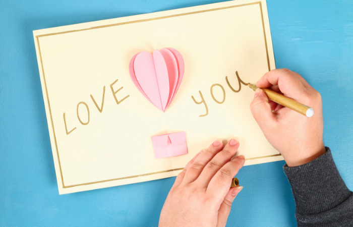 diy valentine's day card for kids writing Love You inside of a card.