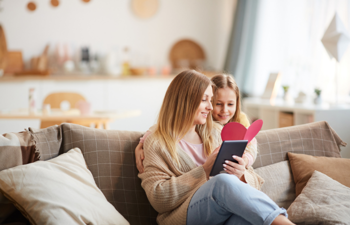 mom and daughter on couch reading - how to get a teenager to talk about their feelings