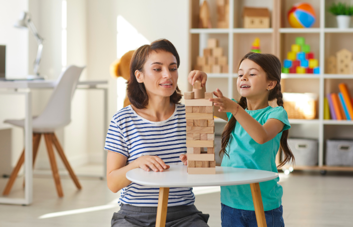 things kids need from their parents mom and daughter playing jenga