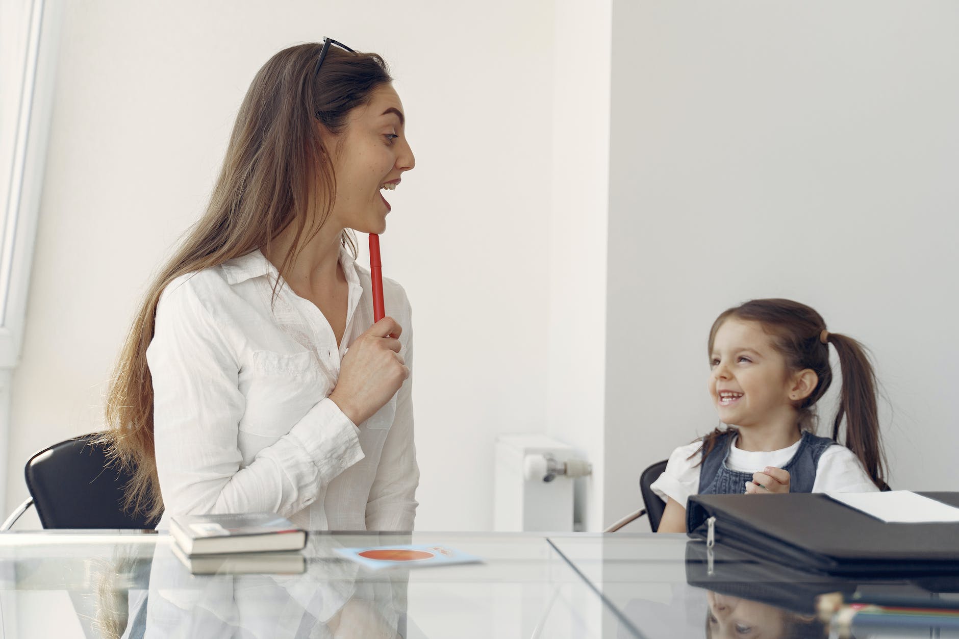 cheerful woman and kid having fun in office - mom and daughter date ideas