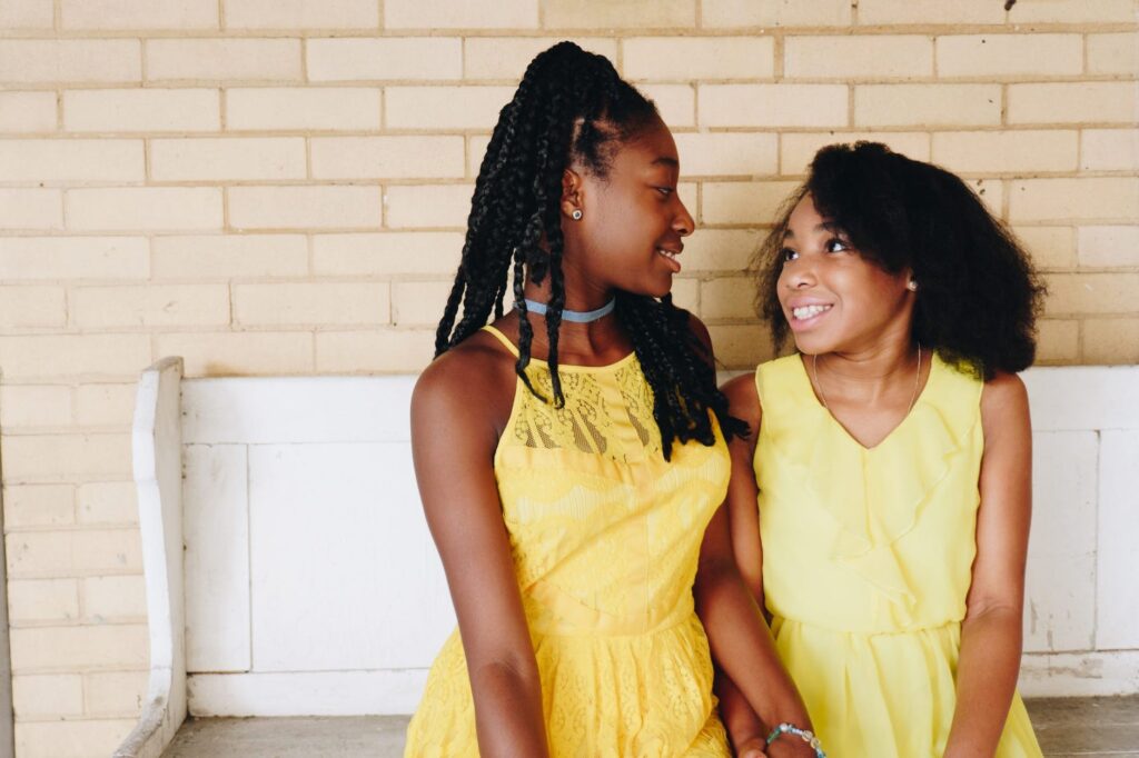 two girls wearing yellow sleeveless dresses how to get a teenager to talk about their feelings