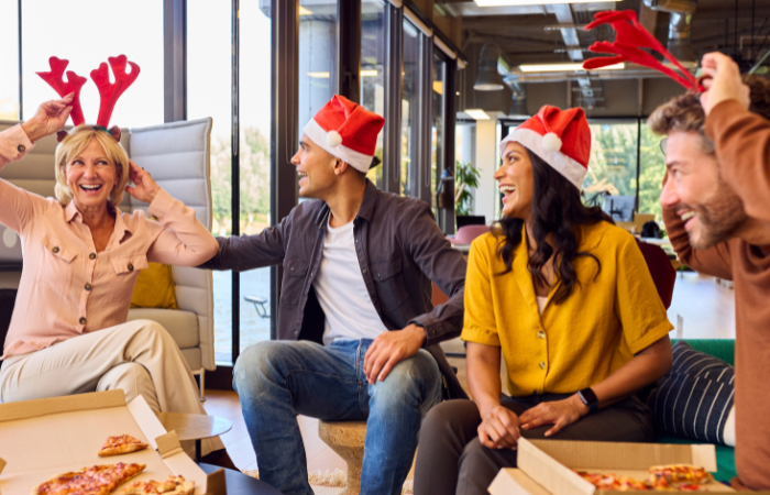 12 days of christmas ideas for work group of people wearing santa hats and reindeer  antlers
