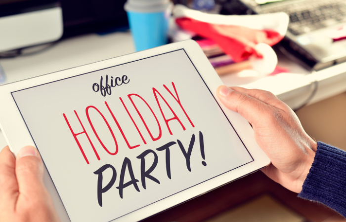 person holding sign that says office holiday party