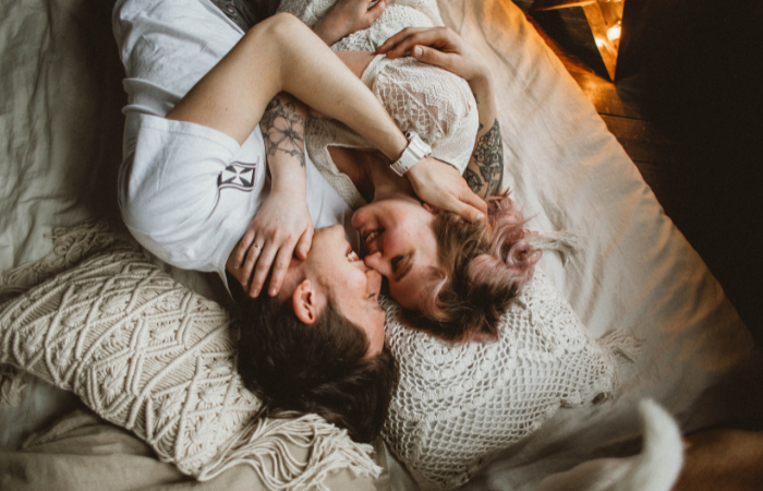 couple in a romantic embrace lying down. how to keep the spark alive in marriage