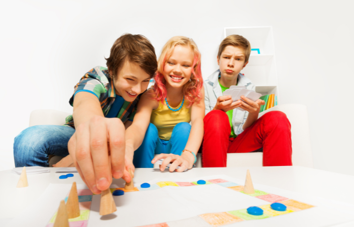 3 teens playing a board game, Teenage date ideas