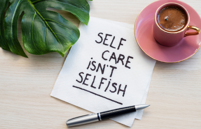 a table top with a note that says self care isn't selfish