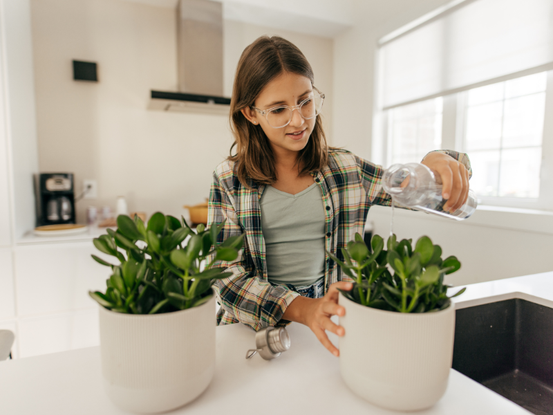 girl watering plants chore list for teens