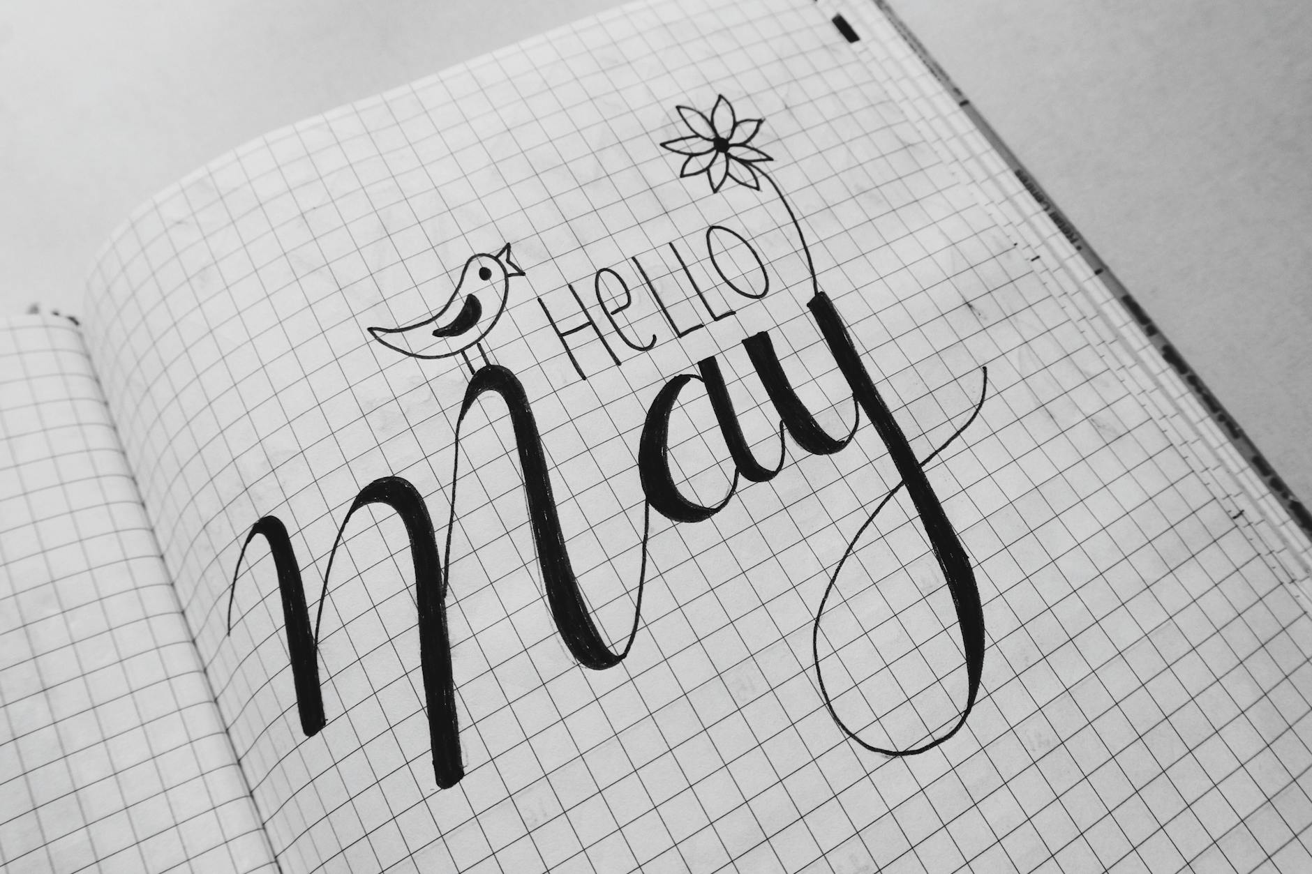 white graphing paper with hello may text