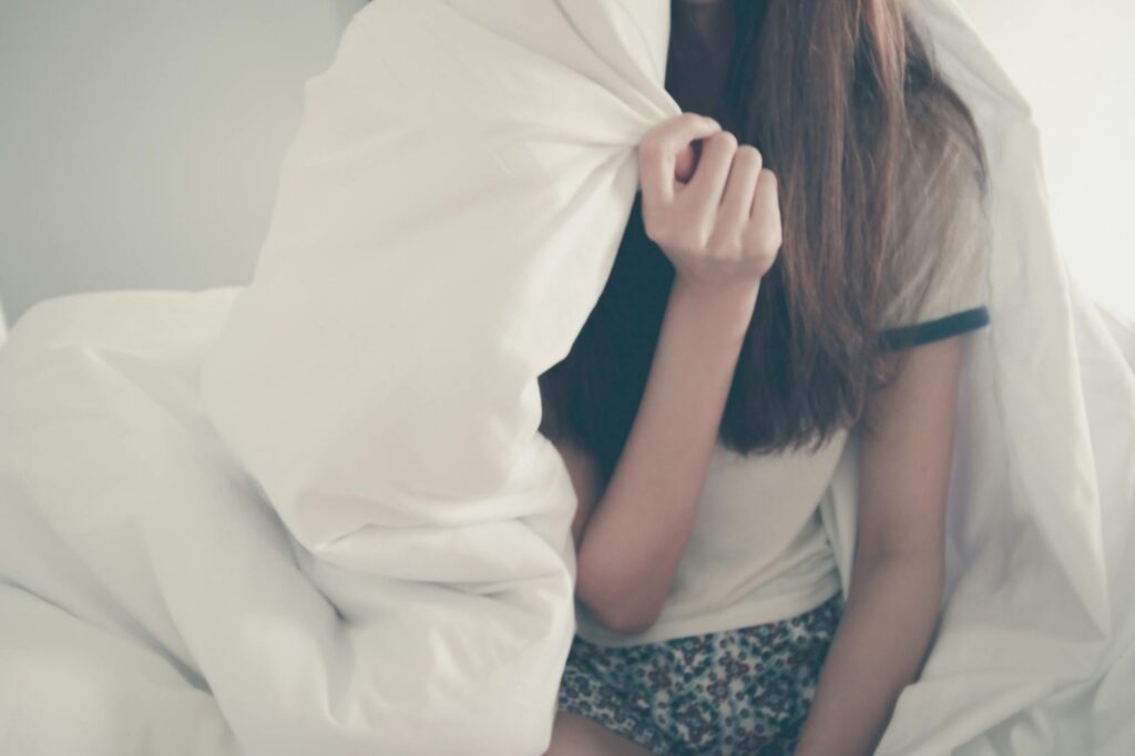 woman under comforter - chore list for teens