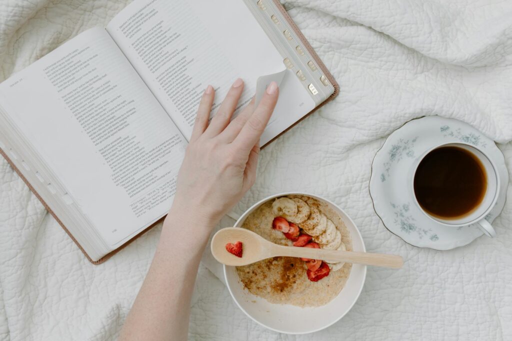 a person having breakfast while reading a book - chore charts for teens