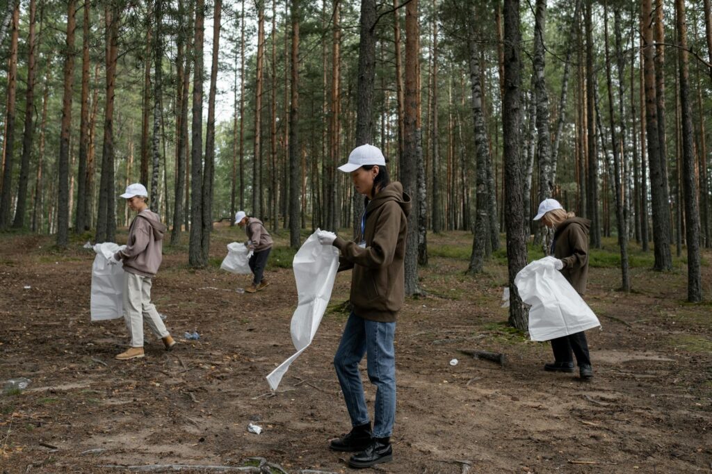 man and woman holding hands while walking on forest