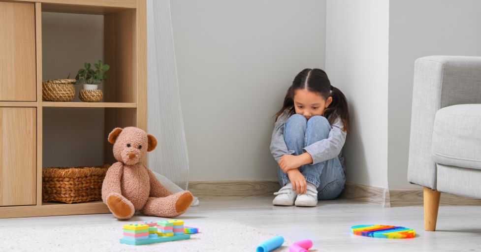 child sitting in a corner