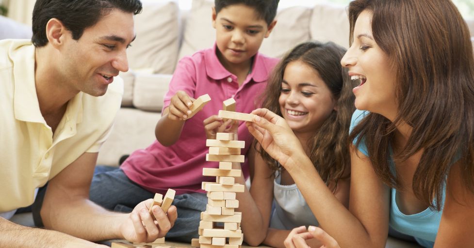 mom, dad, son and daughter playing Jenga