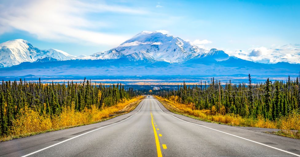 long road leading to mountain range