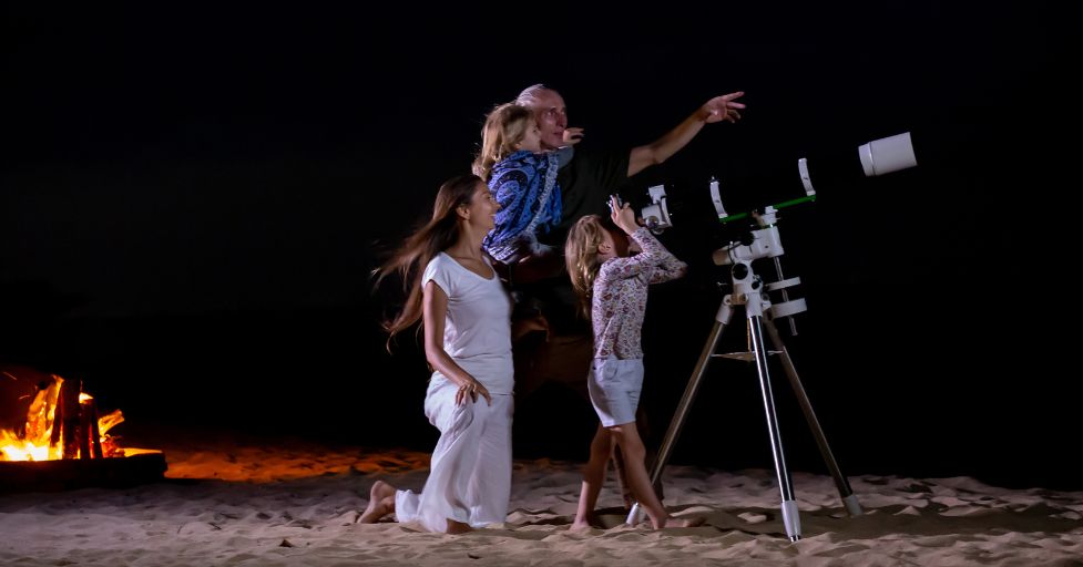 family looking through a telescope