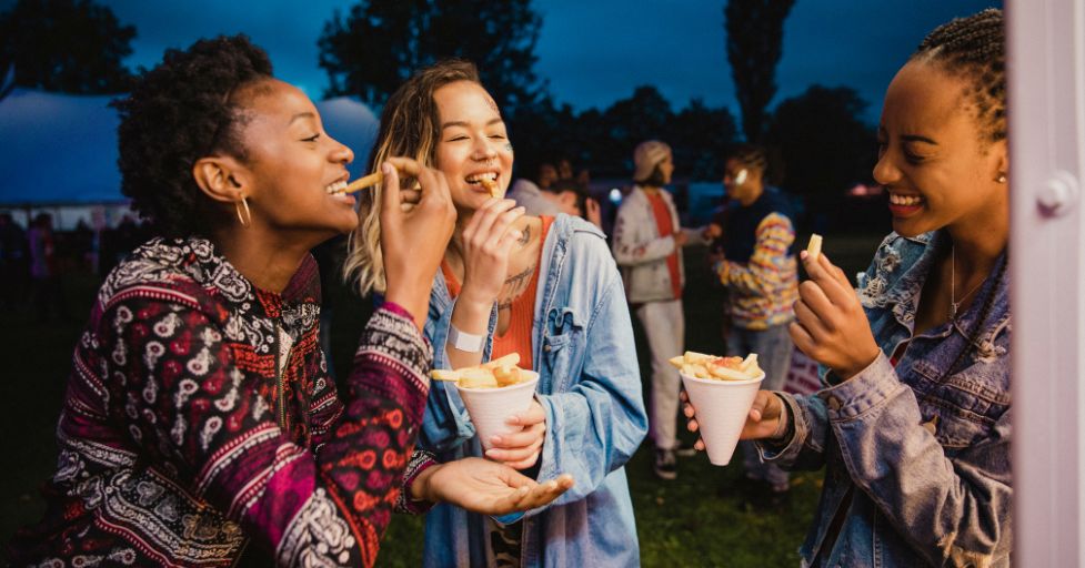 3 women eating food 