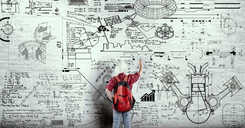 kids standing in front of a huge white board with equations