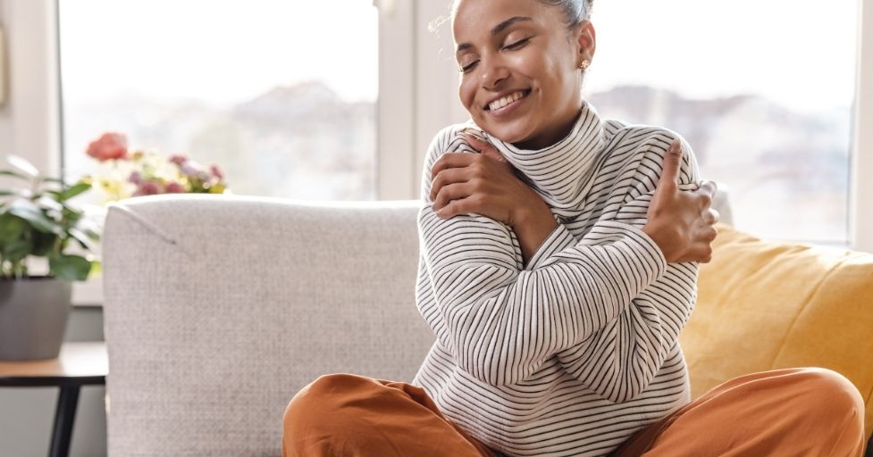 woman hugging herself