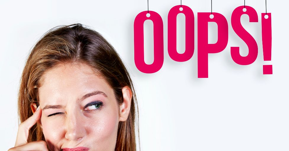 girl touching her forehead with the word "oops" next to her