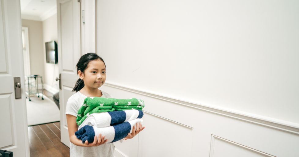 girl carrying laundry