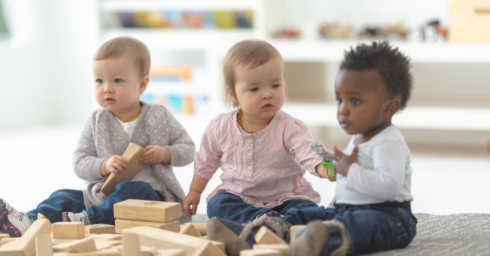 toddlers playing with blocks