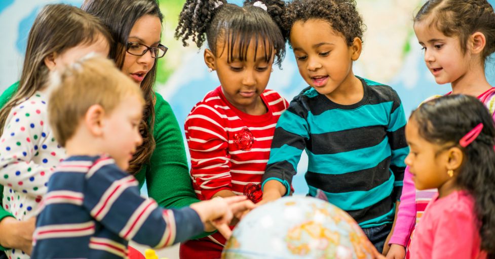 kids looking at a globe