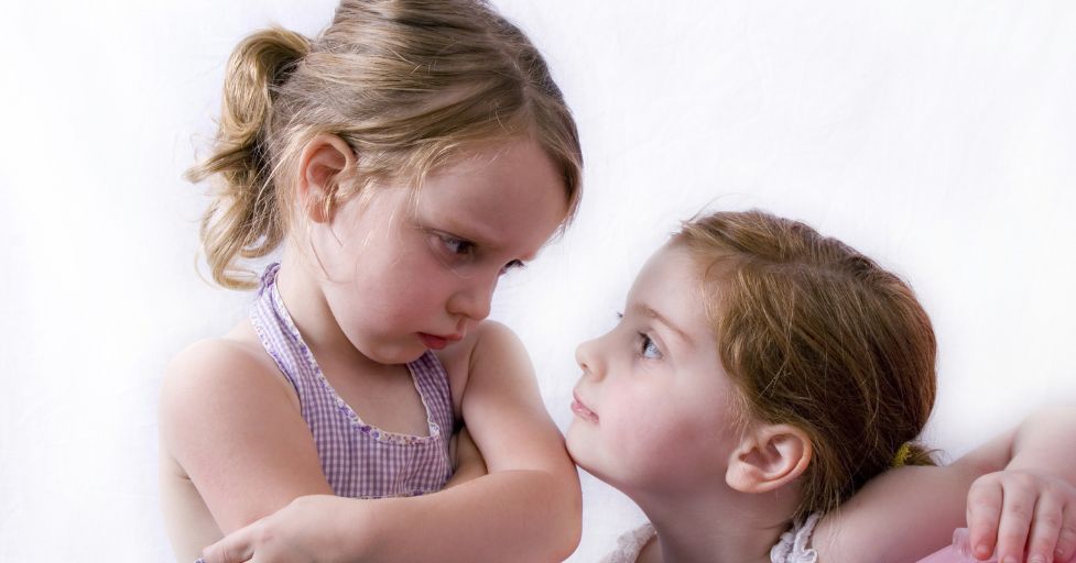 two sisters looking at each other angrily