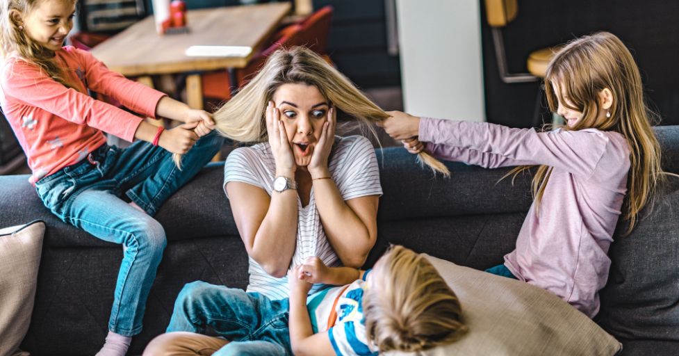 mom getting her hair pulled by two kids