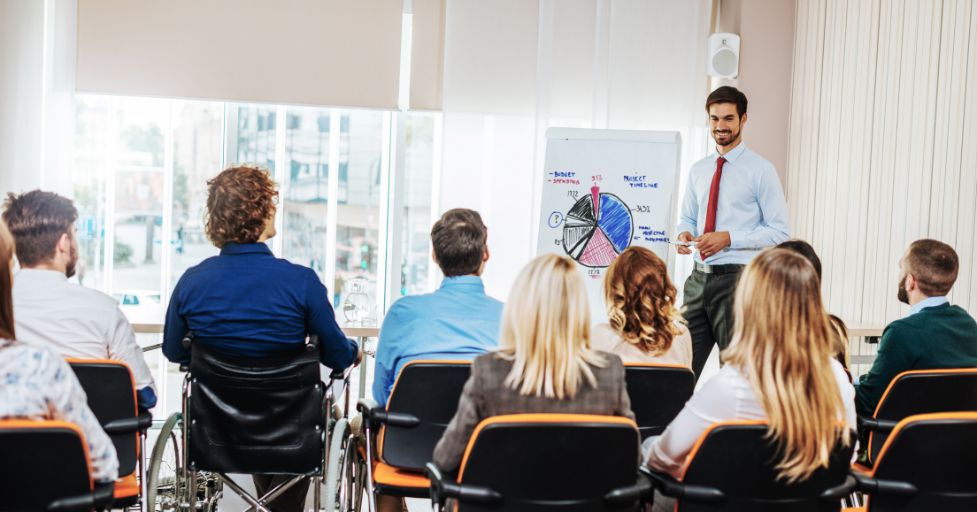 man giving a lecture to a group of adults