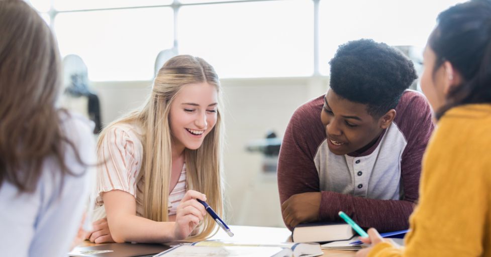 teens sitting around a table
