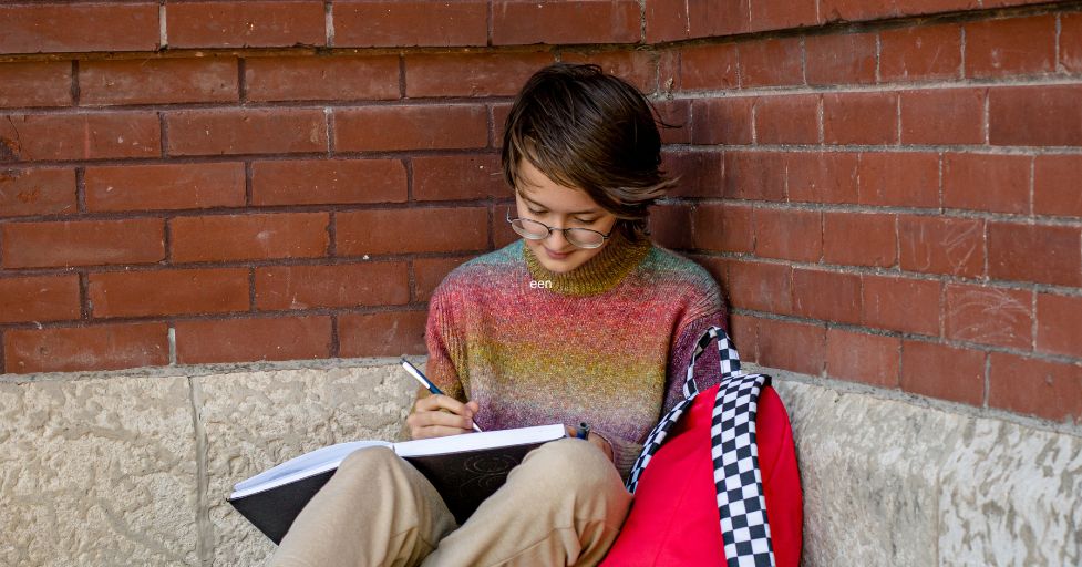 teen writing in journal