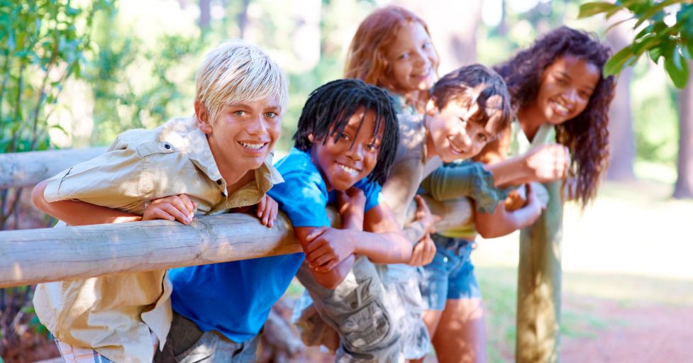 kids up against a wood fence