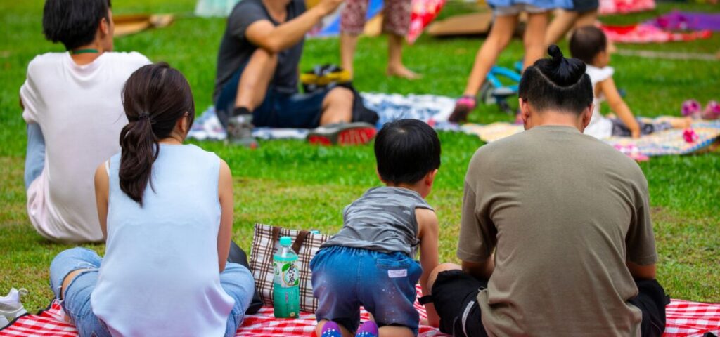 family sitting on a blanket