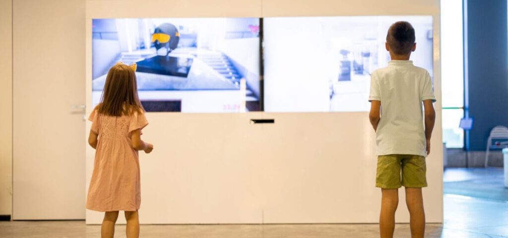 kids playing interactive game in a museum