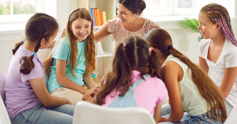 a group of girls sitting in a circle