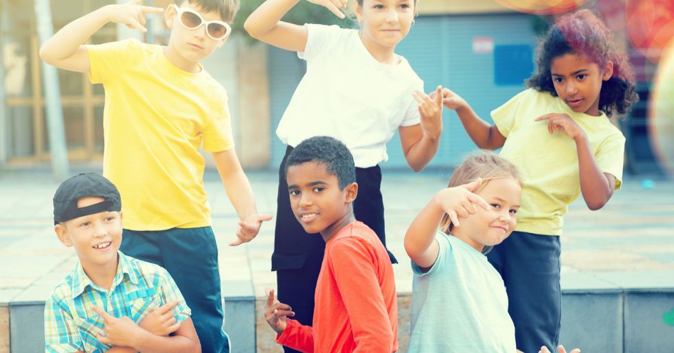 kids posing smiling at the camera