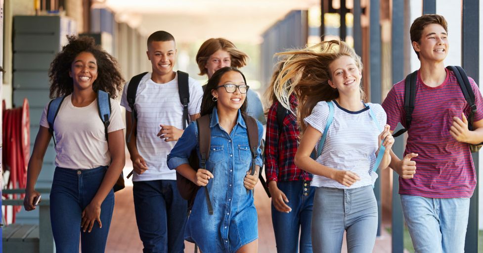 teen kids walking down the hall of a school