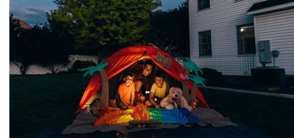 family in a backyard tent