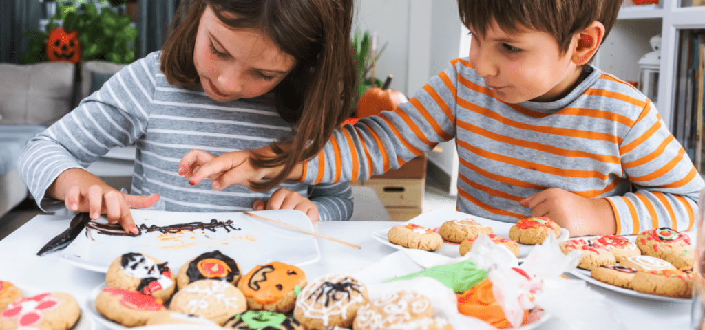 kids decorating Halloween cookies