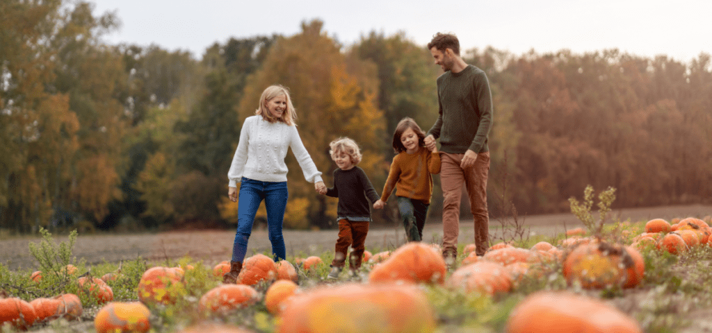 family walking through a pumpkin patch