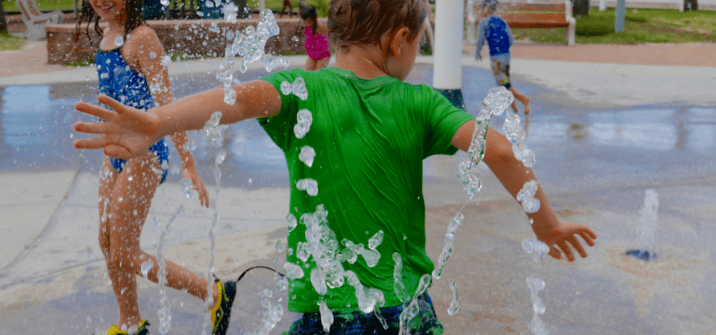 cost-effective family day trips - kids playing in splash pad