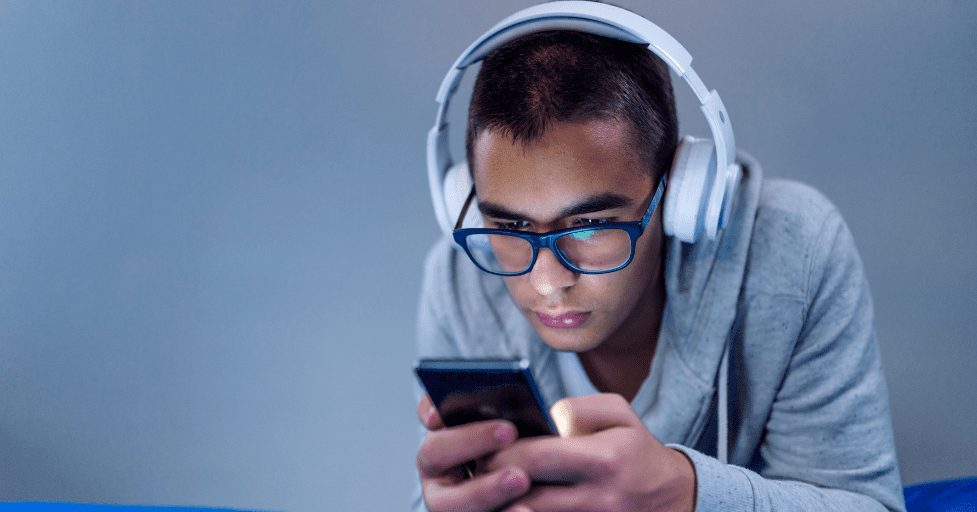 teen boy looking at a cell phone social media impact on teen relationships