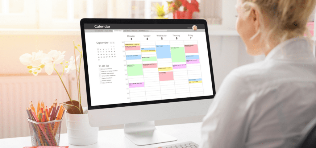 someone looking at a desktop calendar