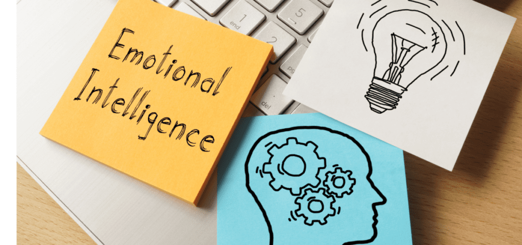 sticky notes that say emotional intelligence a light bulb and the a head